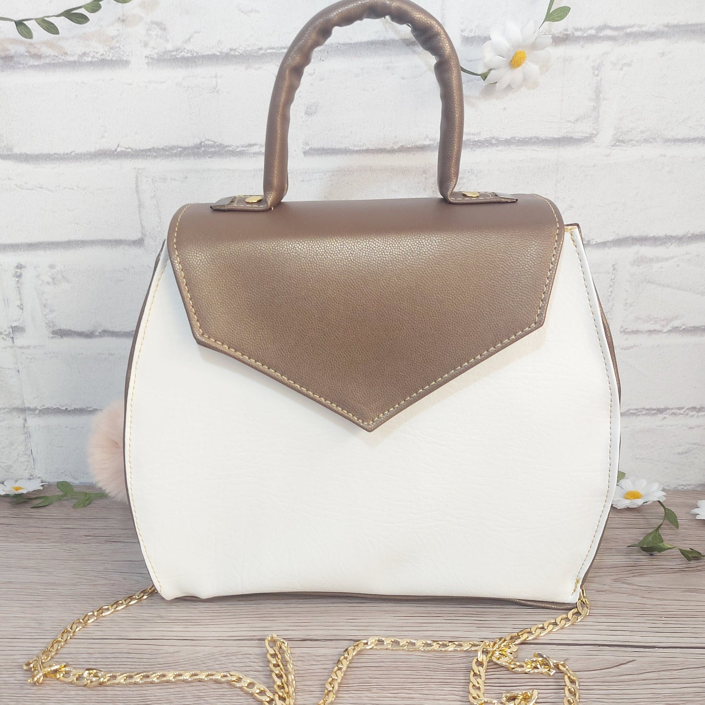 stylish white and copper vegan leather small handbag with detachable gold chain strap.