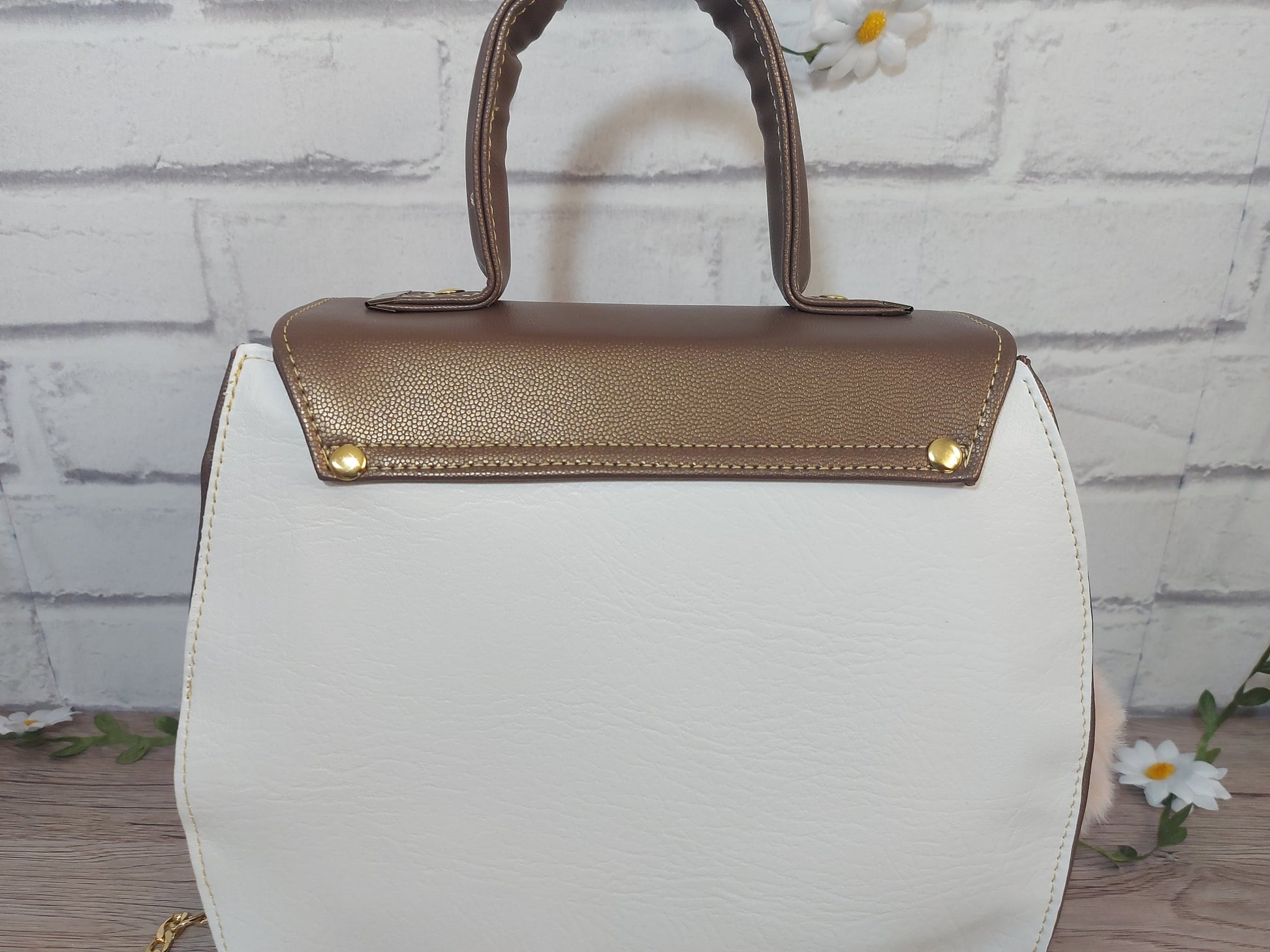 stylish white and copper vegan leather small handbag with detachable gold chain strap.